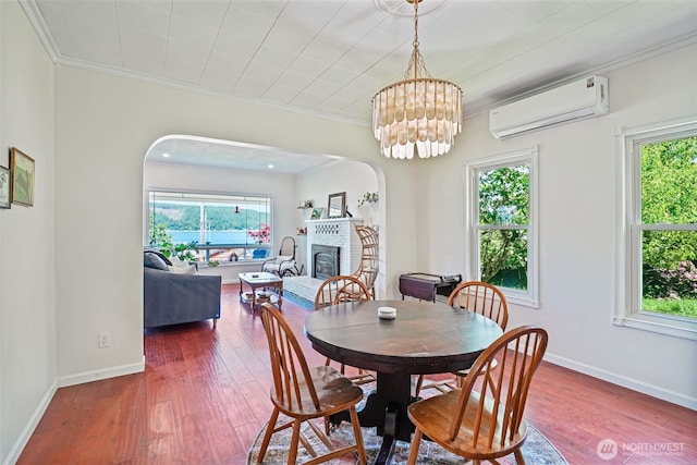 5060 E State Route 106, Union, WA 98592 - dining space featuring plenty of natural light, an AC wall unit, wood-type flooring, and crown molding