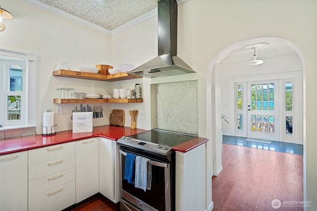 5060 E State Route 106, Union, WA 98592 - kitchen with wall chimney exhaust hood, stainless steel electric range, arched walkways, dark wood-style flooring, and crown molding