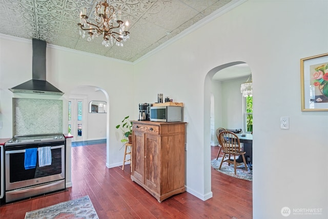 5060 E State Route 106, Union, WA 98592 - kitchen featuring wall chimney exhaust hood, stainless steel appliances, arched walkways, a chandelier, and an ornate ceiling
