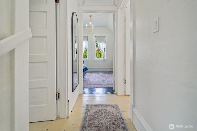 5060 E State Route 106, Union, WA 98592 - hall featuring a chandelier, light wood-style floors, and lofted ceiling