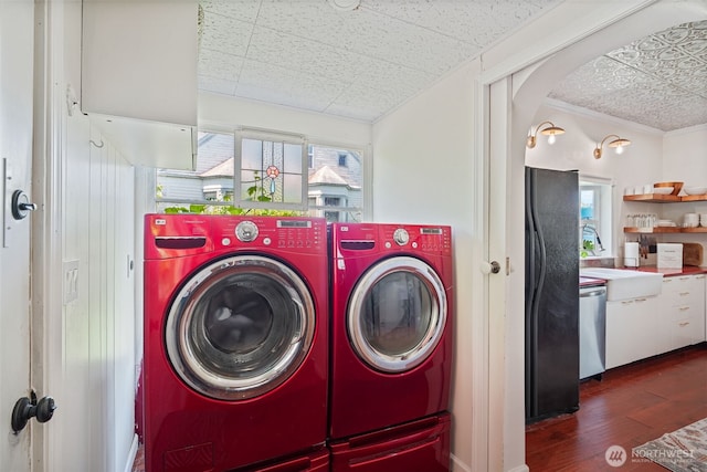 5060 E State Route 106, Union, WA 98592 - laundry area featuring washing machine and dryer, wood finished floors, arched walkways, and ornamental molding