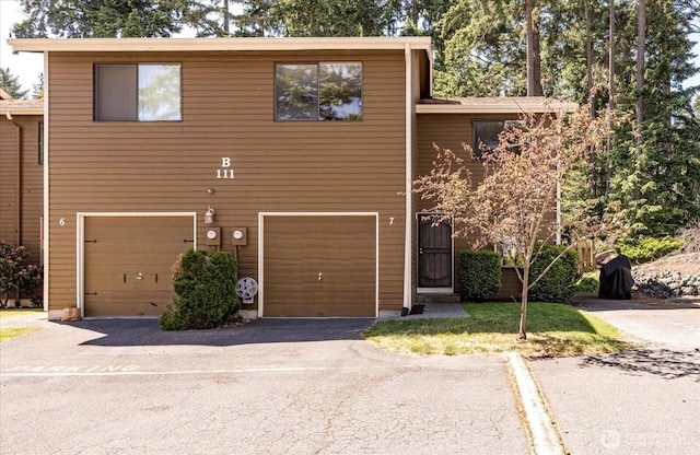 111 NW Columbia Dr Unit B7, Oak Harbor, WA 98277 - view of property featuring driveway and a garage