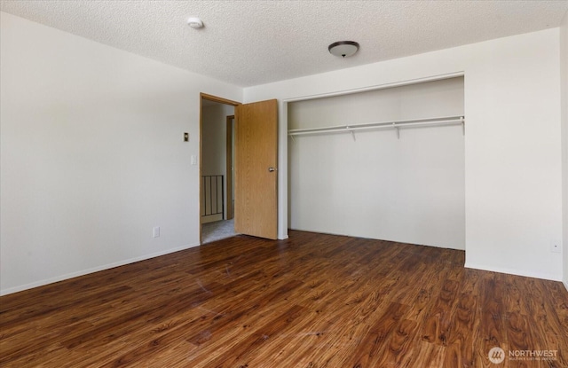 111 NW Columbia Dr Unit B7, Oak Harbor, WA 98277 - unfurnished bedroom featuring wood finished floors, a closet, and a textured ceiling