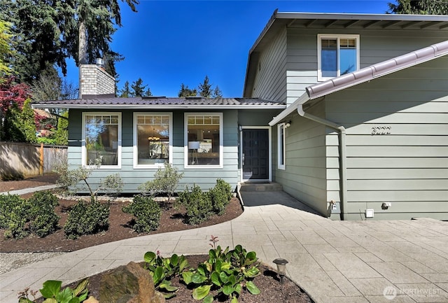 3222 107th Ave SE, Bellevue, WA 98004 - view of front of home with a chimney and metal roof