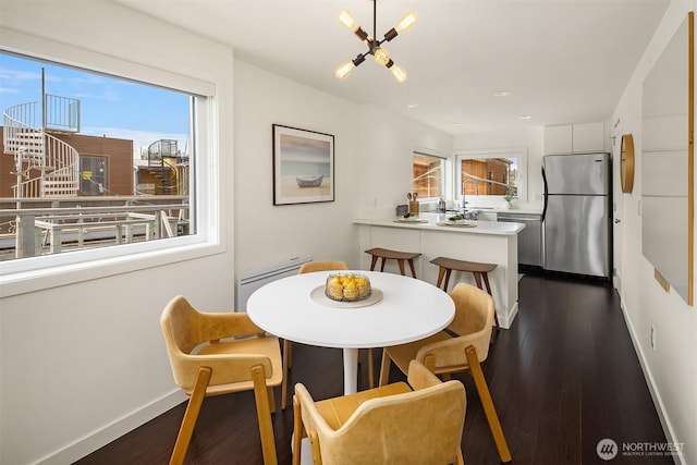 2031 Fairview Ave E Unit E, Seattle, WA 98102 - dining area with baseboard heating, dark wood-type flooring, plenty of natural light, and a chandelier