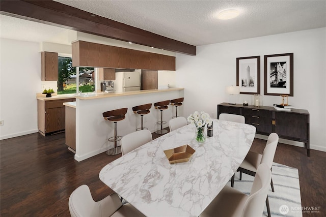16817 21st Ave E, Spanaway, WA 98387 - dining room with dark wood-style flooring, beam ceiling, a textured ceiling, and baseboards
