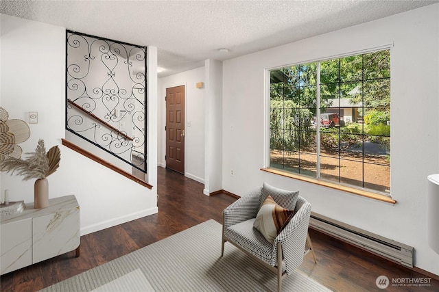 16817 21st Ave E, Spanaway, WA 98387 - sitting room featuring a baseboard heating unit, wood finished floors, a textured ceiling, and baseboards