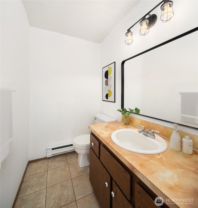 16817 21st Ave E, Spanaway, WA 98387 - half bathroom featuring baseboard heating, toilet, vanity, tile patterned floors, and baseboards