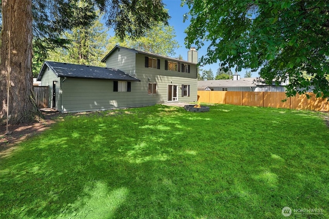 16817 21st Ave E, Spanaway, WA 98387 - back of house featuring a chimney and a fire pit