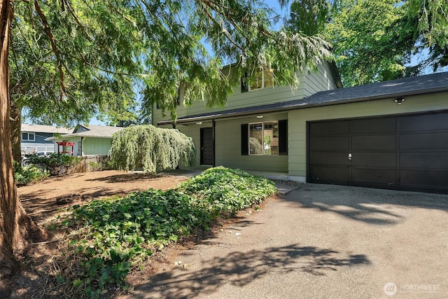 16817 21st Ave E, Spanaway, WA 98387 - view of property hidden behind natural elements with asphalt driveway and an attached garage