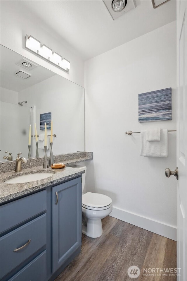12307 NE 97th St Unit B, Kirkland, WA 98033 - bathroom featuring vanity, wood finished floors, toilet, a shower, and baseboards