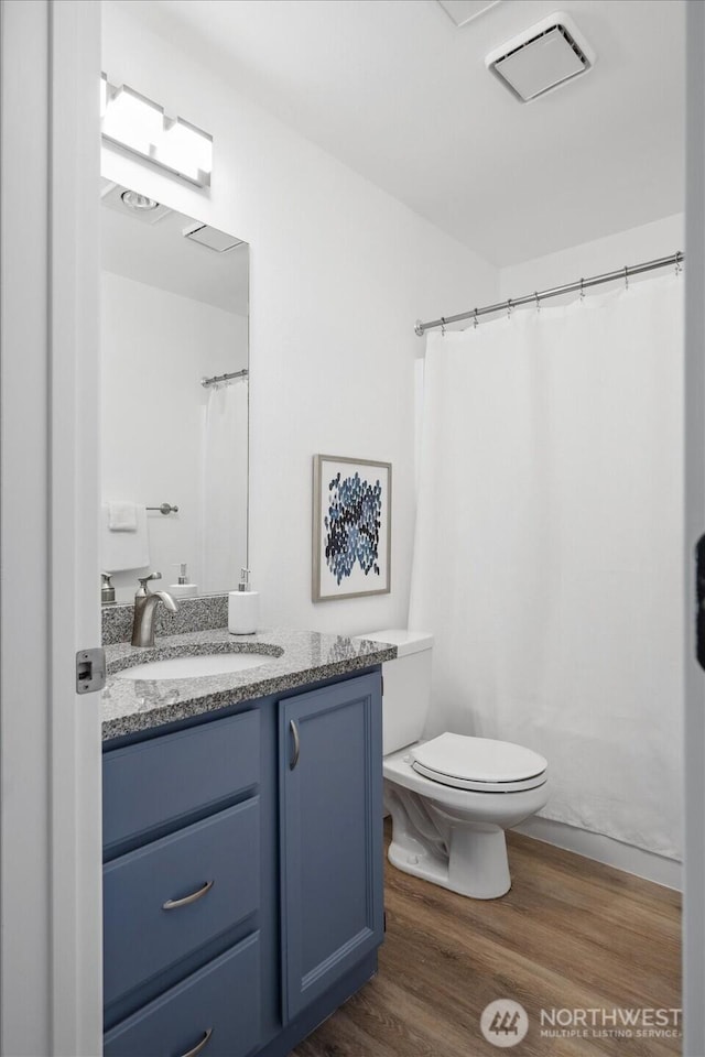 12307 NE 97th St Unit B, Kirkland, WA 98033 - bathroom featuring vanity, toilet, wood finished floors, and curtained shower