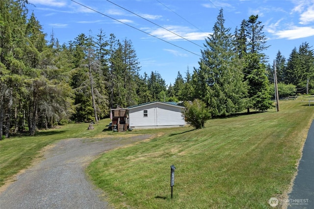 1269 Hideaway Ln, Oak Harbor, WA 98277 - manufactured / mobile home with driveway, a front lawn, and a wooded view