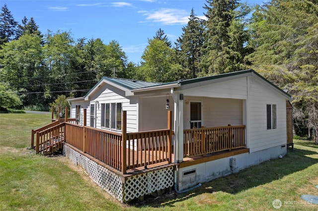 1269 Hideaway Ln, Oak Harbor, WA 98277 - back of house with a yard, metal roof, a standing seam roof, and covered porch