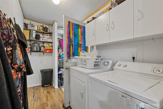 1269 Hideaway Ln, Oak Harbor, WA 98277 - washroom with washing machine and dryer, cabinet space, light wood-type flooring, and a textured ceiling