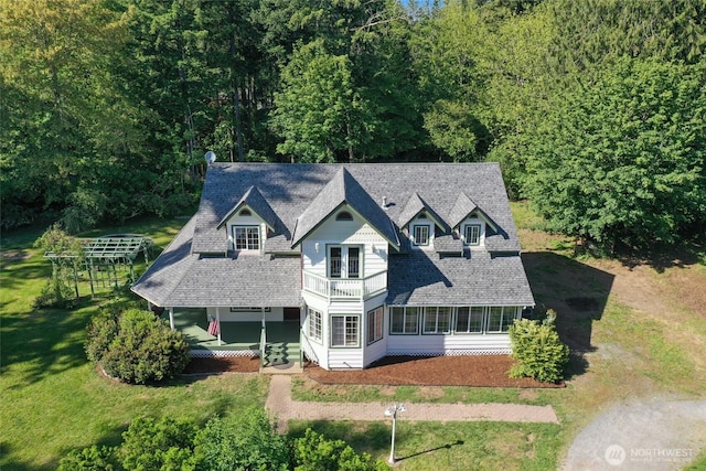 15329 Mckee Ln SE, Yelm, WA 98597 - victorian house featuring covered porch, a front yard, a shingled roof, a sunroom, and a forest view