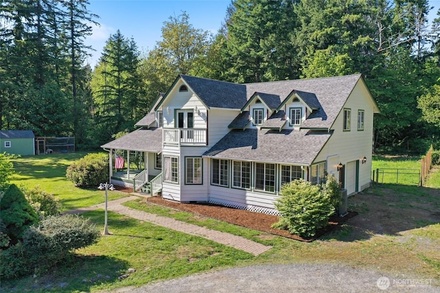 15329 Mckee Ln SE, Yelm, WA 98597 - view of front of property featuring a balcony, an attached garage, roof with shingles, driveway, and a porch