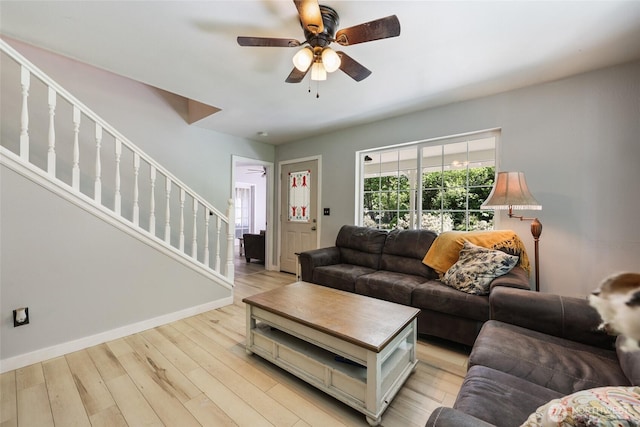 15329 Mckee Ln SE, Yelm, WA 98597 - living area with stairway, a ceiling fan, baseboards, and light wood-style flooring