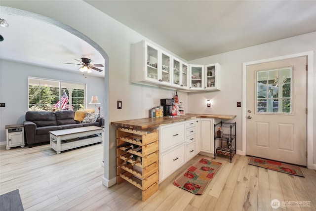 15329 Mckee Ln SE, Yelm, WA 98597 - bar area with light wood-type flooring, ceiling fan, and baseboards