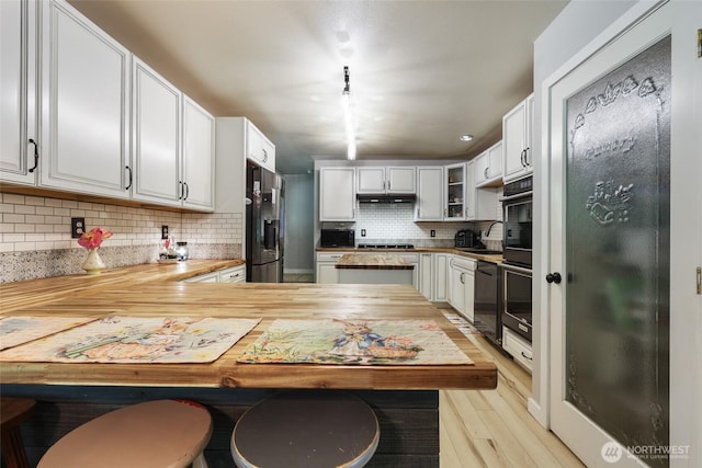 15329 Mckee Ln SE, Yelm, WA 98597 - kitchen with refrigerator with ice dispenser, decorative backsplash, a peninsula, dishwasher, and light wood-type flooring