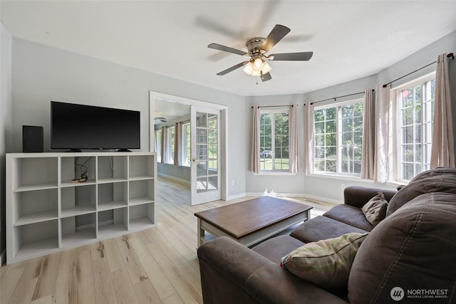 15329 Mckee Ln SE, Yelm, WA 98597 - living room featuring wood finished floors, plenty of natural light, a ceiling fan, and baseboards