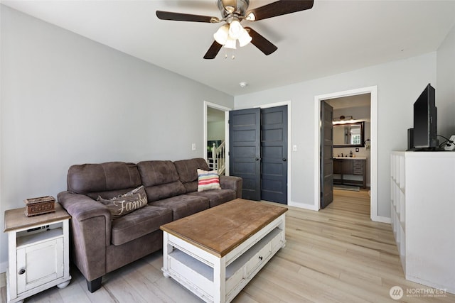 15329 Mckee Ln SE, Yelm, WA 98597 - living room with a ceiling fan, light wood finished floors, and baseboards