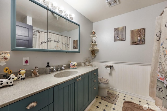15329 Mckee Ln SE, Yelm, WA 98597 - bathroom with vanity, toilet, a wainscoted wall, tile patterned floors, and a shower with curtain