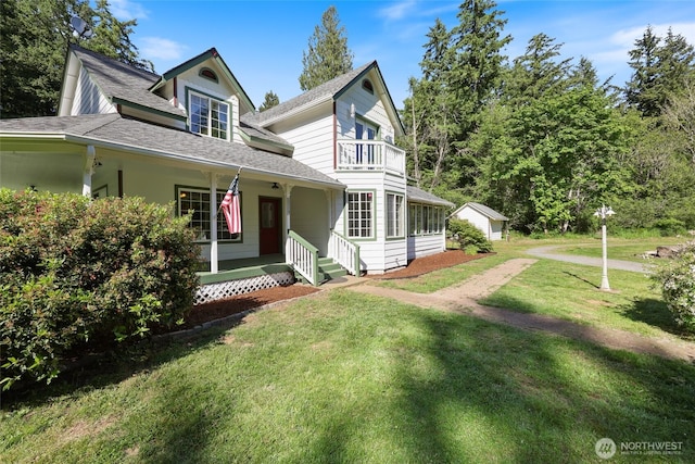15329 Mckee Ln SE, Yelm, WA 98597 - view of front of house with a balcony, a front yard, a shingled roof, and covered porch
