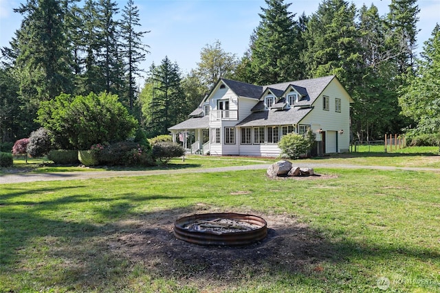 15329 Mckee Ln SE, Yelm, WA 98597 - traditional home featuring a fire pit, a garage, and a front yard