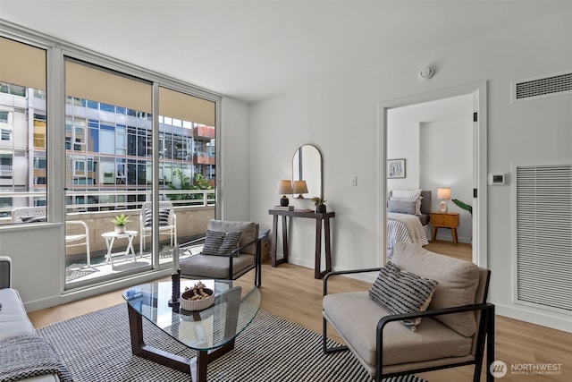 2600 2nd Ave Unit 504, Seattle, WA 98121 - living area featuring light wood-style flooring, baseboards, and a heating unit