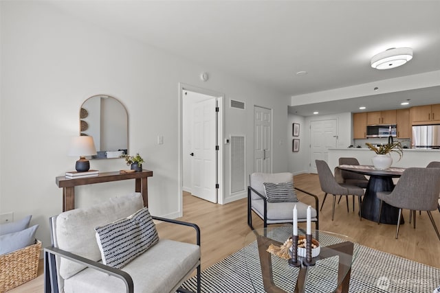 2600 2nd Ave Unit 504, Seattle, WA 98121 - living area with light wood-style floors, recessed lighting, and baseboards
