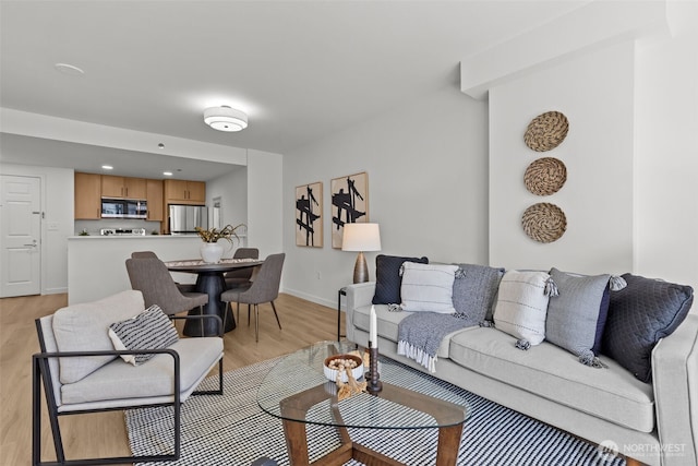 2600 2nd Ave Unit 504, Seattle, WA 98121 - living room with light wood-style floors, baseboards, and recessed lighting