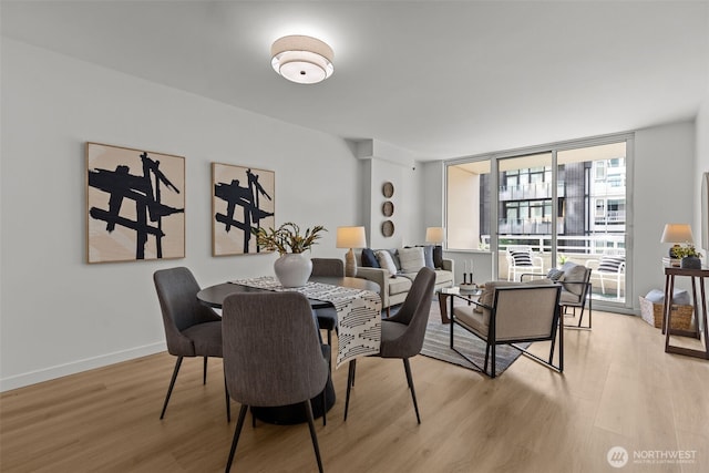 2600 2nd Ave Unit 504, Seattle, WA 98121 - dining room with light wood-style floors and baseboards