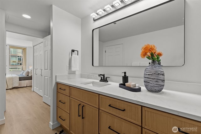 2600 2nd Ave Unit 504, Seattle, WA 98121 - bathroom featuring vanity, wood finished floors, and recessed lighting