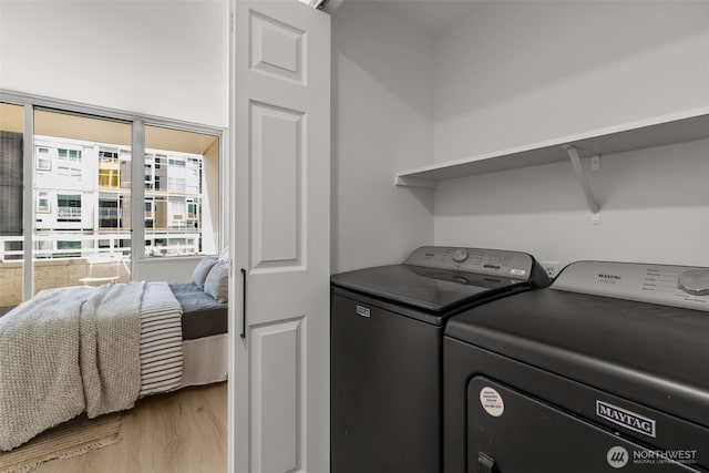 2600 2nd Ave Unit 504, Seattle, WA 98121 - laundry room featuring washing machine and clothes dryer and light wood-type flooring