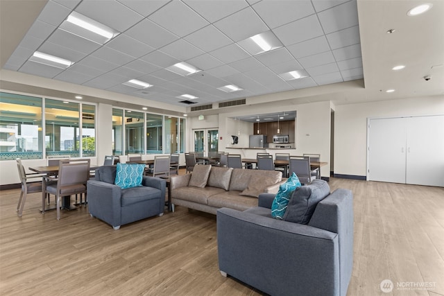 2600 2nd Ave Unit 504, Seattle, WA 98121 - living area featuring light wood-type flooring and a drop ceiling