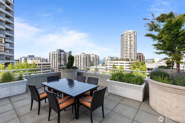 2600 2nd Ave Unit 504, Seattle, WA 98121 - view of patio / terrace with a view of city and outdoor dining space