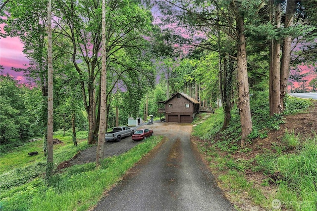 214 Inglewood Dr, Longview, WA 98632 - view of asphalt driveway featuring a forest view