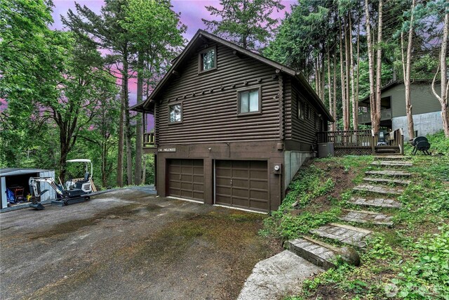 214 Inglewood Dr, Longview, WA 98632 - view of property exterior featuring driveway, an attached garage, a deck, and stairway