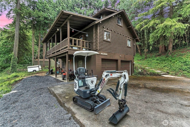 214 Inglewood Dr, Longview, WA 98632 - chalet / cabin with an attached garage, driveway, a wooden deck, and log exterior