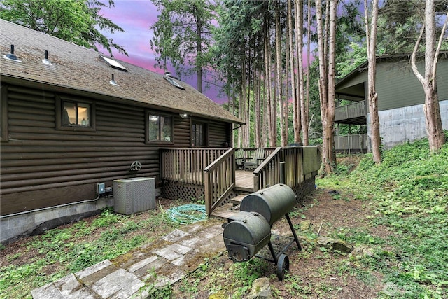 214 Inglewood Dr, Longview, WA 98632 - yard at dusk featuring central air condition unit and a deck