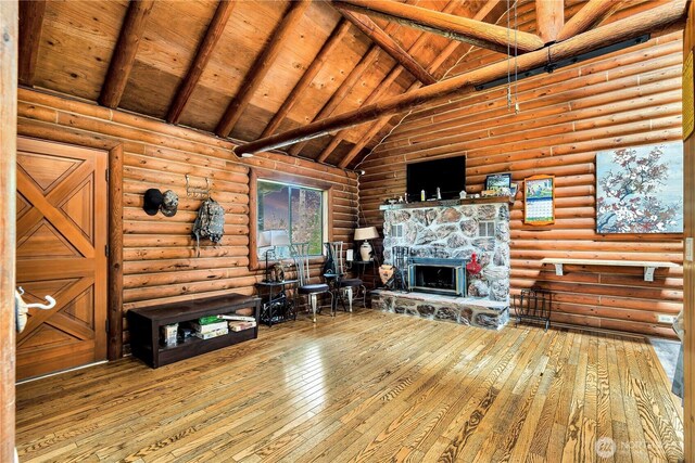 214 Inglewood Dr, Longview, WA 98632 - living room with hardwood / wood-style floors, high vaulted ceiling, a stone fireplace, wood ceiling with exposed beams, and rustic walls