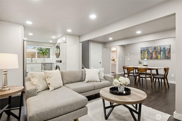 628 163rd Ave SE, Bellevue, WA 98008 - living area with light wood-type flooring, stacked washing machine and dryer, recessed lighting, and baseboards