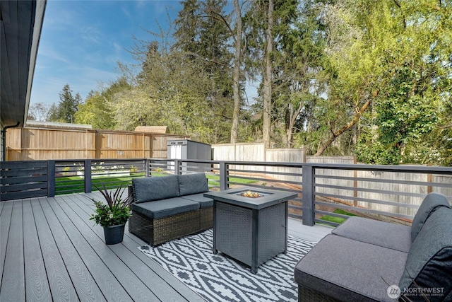 628 163rd Ave SE, Bellevue, WA 98008 - wooden deck featuring a fenced backyard, an outdoor living space with a fire pit, and view of wooded area