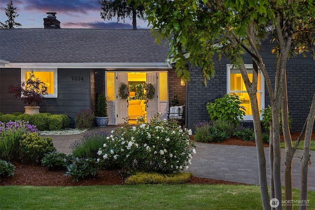 7834 SE 75th Pl, Mercer Island, WA 98040 - view of front of house with a chimney, brick siding, and roof with shingles