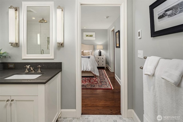 7834 SE 75th Pl, Mercer Island, WA 98040 - full bathroom with vanity, wood finished floors, a shower, connected bathroom, and baseboards