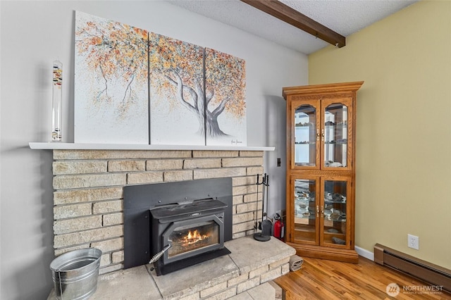 13524 E 5th Ave, Spokane Valley, WA 99216 - detailed view of a baseboard radiator, beam ceiling, wood finished floors, a fire extinguisher, and a textured ceiling