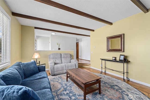13524 E 5th Ave, Spokane Valley, WA 99216 - living area with beamed ceiling, a textured ceiling, plenty of natural light, wood finished floors, and baseboards
