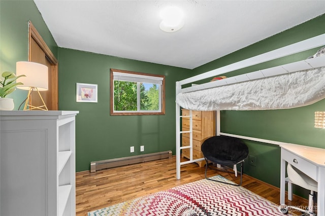 13524 E 5th Ave, Spokane Valley, WA 99216 - bedroom with baseboard heating, wood finished floors, and baseboards