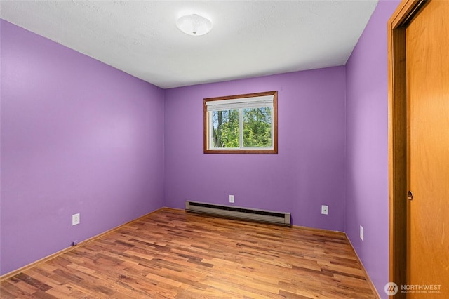 13524 E 5th Ave, Spokane Valley, WA 99216 - spare room featuring a baseboard radiator and wood finished floors